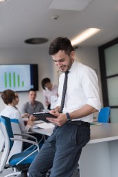 Portrait of happy young businessman with tablet computer office.