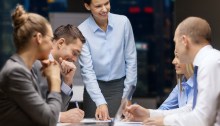 Business coach with work team
