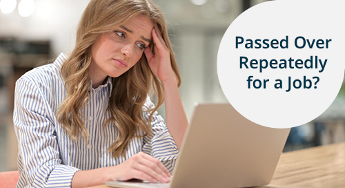 A woman looking stressed and frustrated while working on a laptop, with the text 'Passed Over Repeatedly for a Job?' in a designated area.